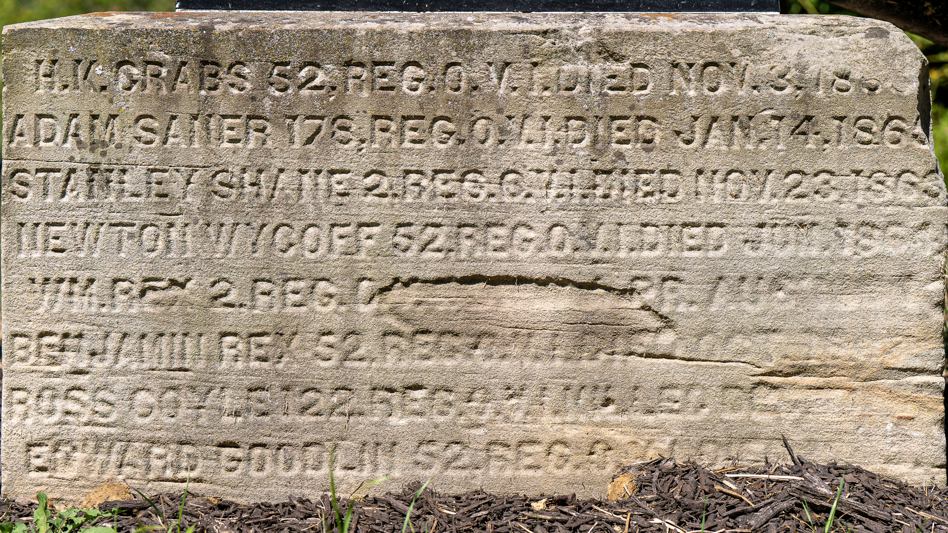Etched sandstone that supports the cannon marked with the names of those the mooretown soldiers monument is dedicated to.
