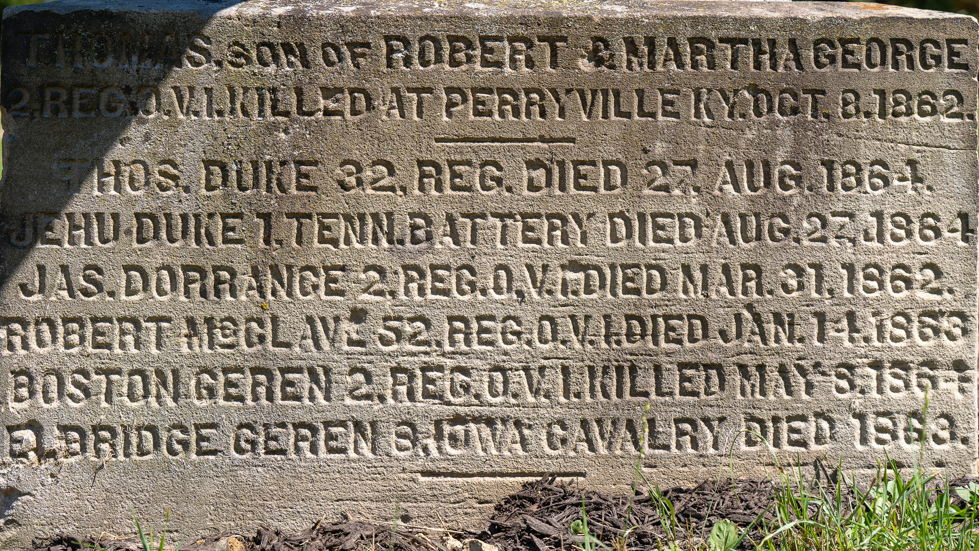 Etched sandstone that supports the cannon marked with the names of those the mooretown soldiers monument is dedicated to.